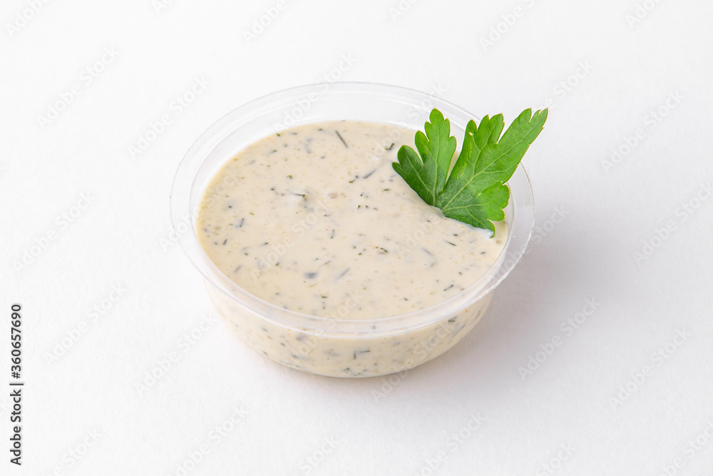 Serving of tar tar sauce in plastic. Topping for dishes for delivery. Isolated on a white background. Serving of tar tar sauce in plastic. Topping for dishes for delivery. Isolated on a white background.