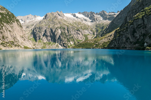 Reflections in the turquoise water of lake Gelmer.