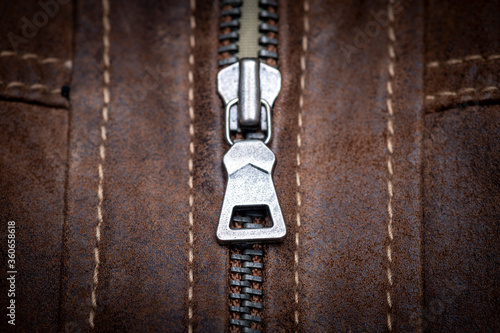 Zip fastener on a brown leather motorcycle jacket