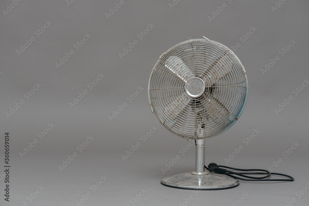 Metal fan on a gray background with copy space.