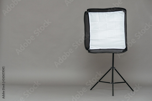 Studio softbox on a tripod on a gray background with copy space. photo