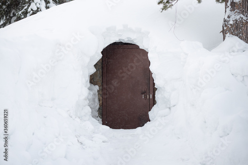 A closed door in a deep snow. © Dmitriy