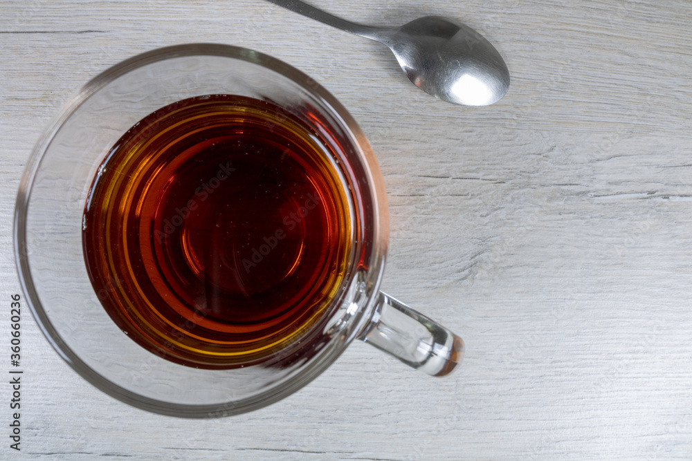 Glass transparent cup with black tea with a top view. Glass transparent cup with black tea with a top view.
