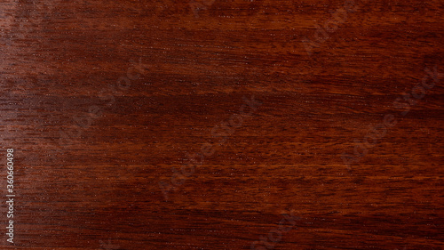 Varnished red tree with original texture. Beautiful brown wood background on lacquered textured plywood.