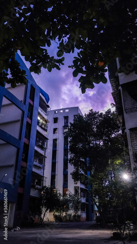 residential colony in Mumbai city society house, real estate Kharghar India ,purple sky , clouds heavy rain, climate change, property dealing, 2bhk ,city towers, family housing. photo