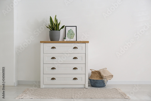 Bild auf Leinwand Stylish chest of drawers in living room interior