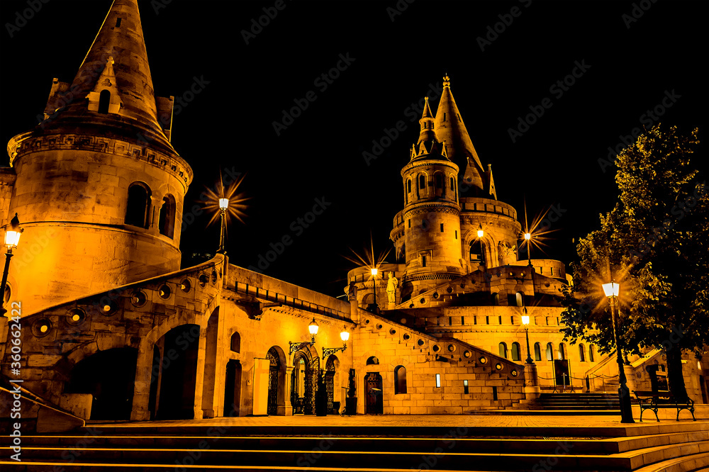 The conical towers of the Fisherman's Bastion in  Budapest at night during the summertime