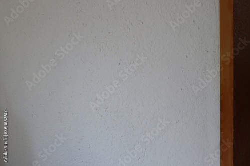 White wall with gold painted door frame