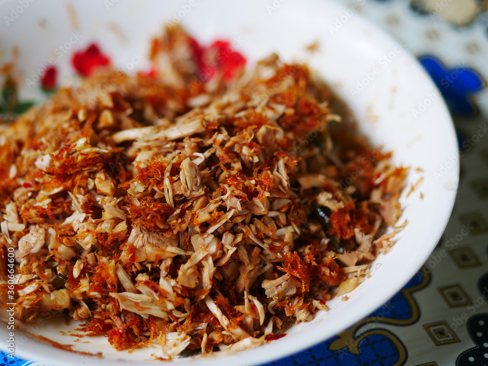 Urap megono is traditional food from Pekalongan, Indonesia served in white plate. Urap Megono is made from young jackfruit which is chopped roughly and mixed with grated coconut and various other herb Urap megono is traditional food from Pekalongan, Indonesia served in white plate. Urap Megono is made from young jackfruit which is chopped roughly and mixed with grated coconut and various other herb