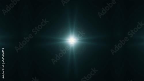 Beautiful lens flare with rays on a black background.