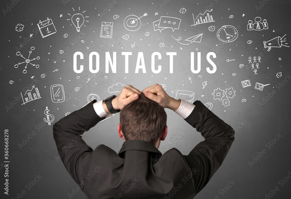 Rear view of a businessman with CONTACT US inscription, modern business concept Rear view of a businessman with CONTACT US inscription, modern business concept