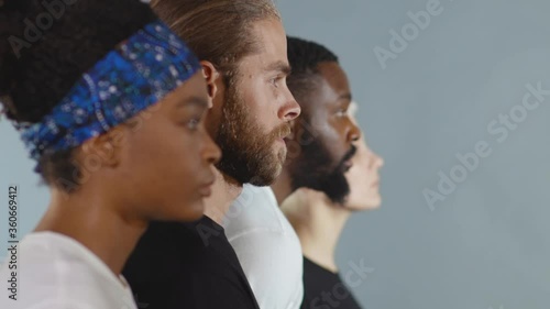 Close up side shot of group of people of different races raise head black white man woman stop racism all people are equal togetherness multiracial peace interracial friendship anti-racism slow motion