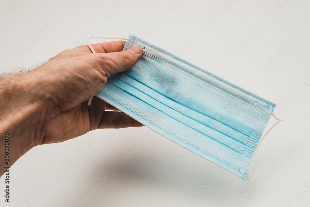 medical mask in the hands of a man, a means of protection against the virus