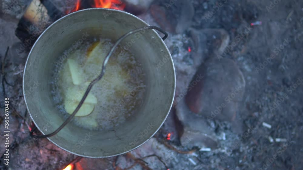 cooking over an open fire. summer camping in nature. bonfire close-up cooking over an open fire. summer camping in nature. bonfire close-up