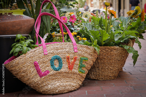 a flower basket on the ground written with the word love.