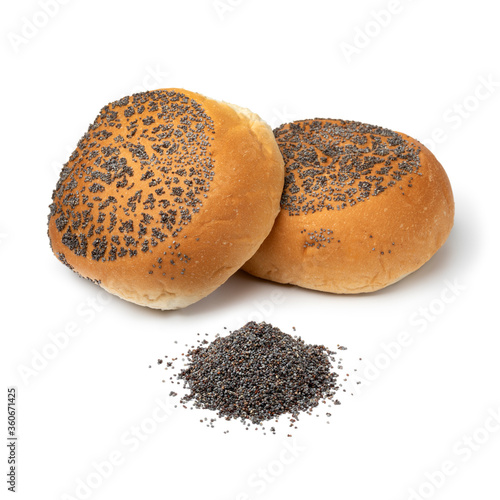 Fresh baked buns with poppy seed and a heap of poppy seed