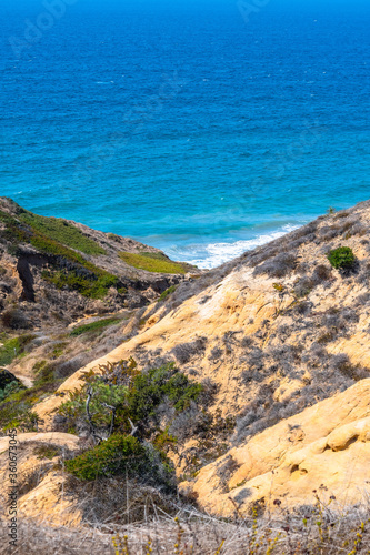 San Diego, California. Sandstone cliffs in desert mountain landscape by the ocean. Torrey Pines State Reserve Park hike trails in Lo Jolla, on warm sunny dry summer day.