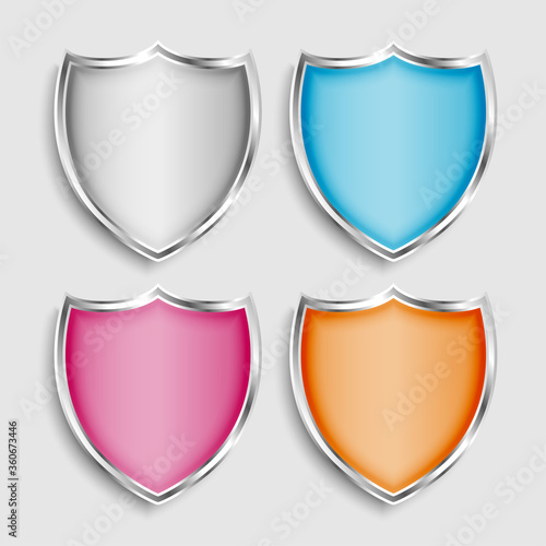 four shiny metallic shield symbols or icons set