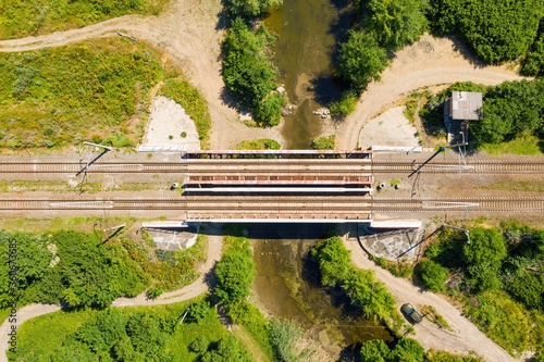 Railway bridge over small river. Aerial view.