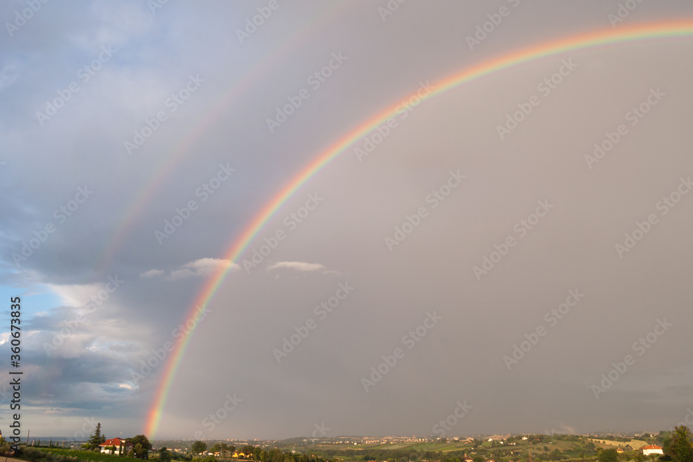 colorful double rainbow on a cloudy and foggy day. colorful double rainbow on a cloudy and foggy day.