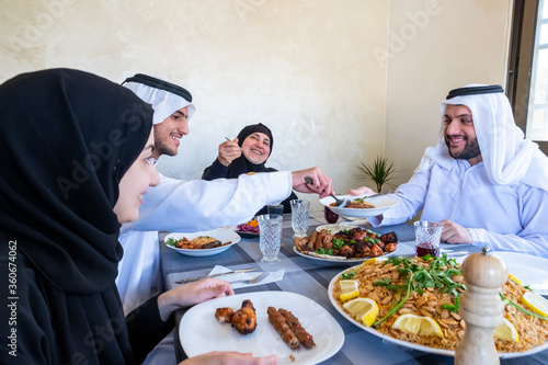 Happy arabic muslim family enjoying the food togther in ramadan