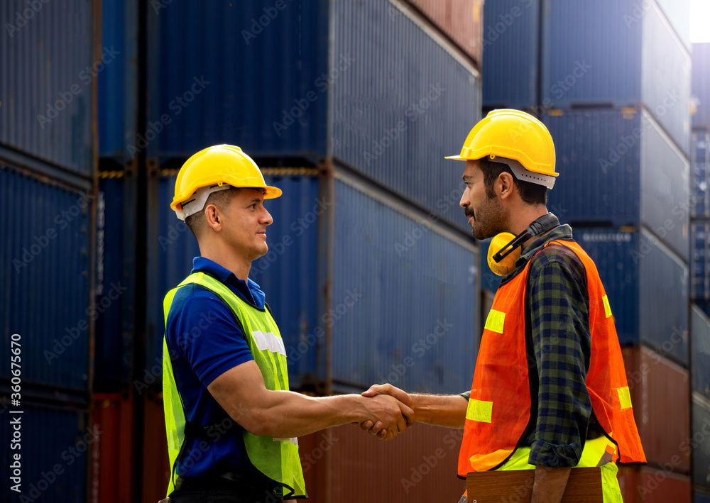 Two Industrial workers or engineers join hands Two Industrial workers or engineers join hands