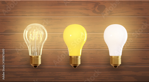 Set of electric lamps, edison, tungsten, fluorescent and led. Isolated on a wood background. Incandescent lamp with bright light. Concept of business idea