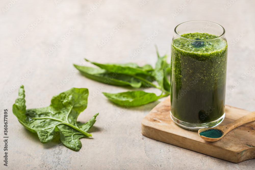 Fototapeta premium Green smoothie with spirulina. Young barley and chlorella spirulina. Detox superfood.