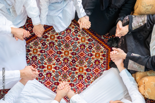 Happy Arabic family holding hands during Ramadan