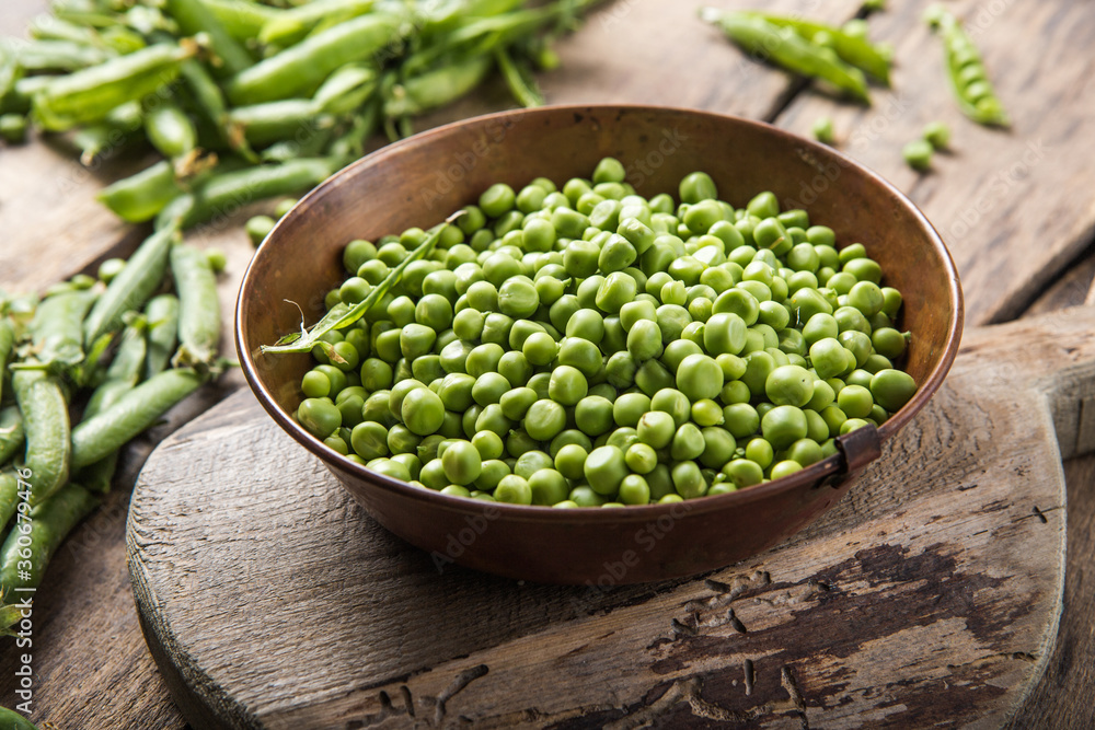 Young fresh green peas on wooden table viewed from above Young fresh green peas on wooden table viewed from above