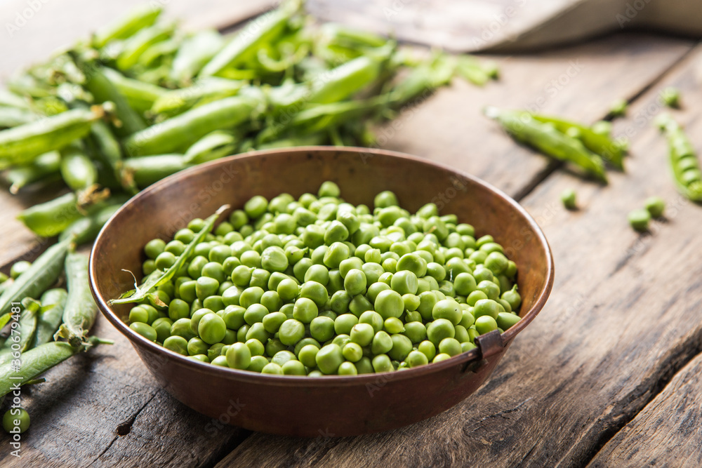 Young fresh green peas on wooden table viewed from above Young fresh green peas on wooden table viewed from above