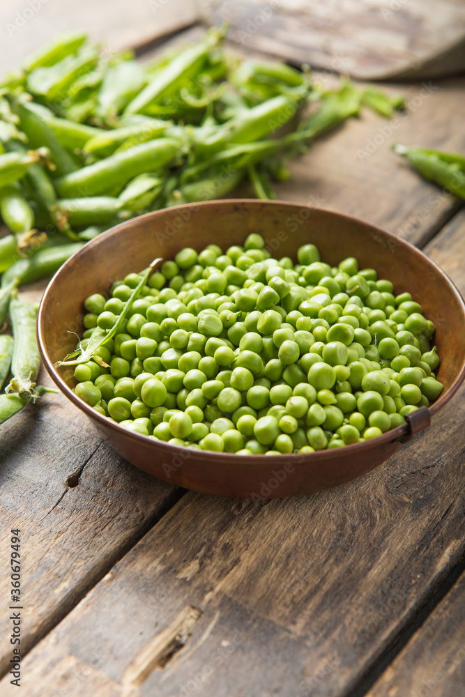 Young fresh green peas on wooden table viewed from above Young fresh green peas on wooden table viewed from above