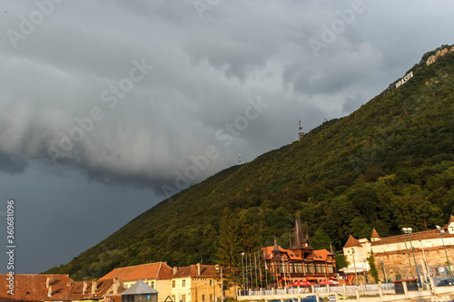 BRASOV, ROMANIA - Circa 2020: Storm clouds building up over a green hill. Concept of wild weather. Storm season.