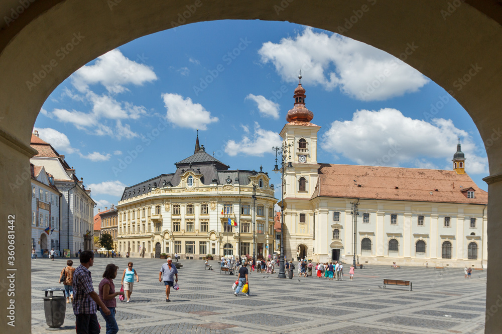 Obraz premium SIBIU, ROMANIA - Circa 2020: Old medieval town with cloudy blue sky. Beautiful tourist spot in eastern central Europe. Famous Big Square in Sibiu Romania