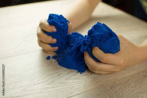 Child playing with kinetic sand.
