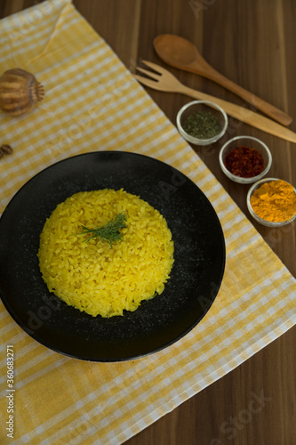 cooking rice with Curcuma Longa, turmeric or Zerdecal for healthy life photo