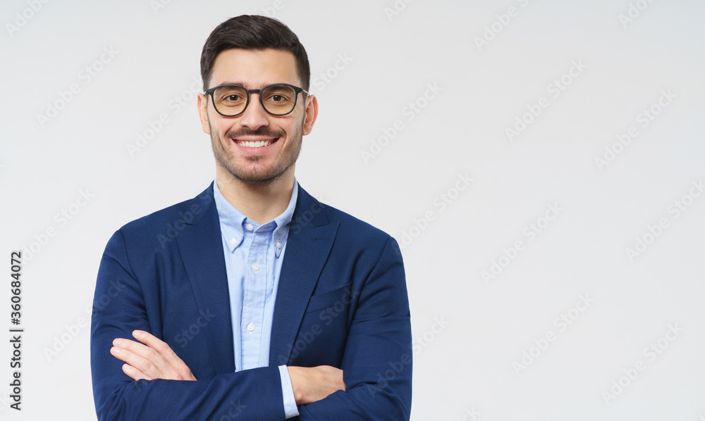 Banner of smart business man standing against gray background isolated with copy space, looking at camera with happy face and crossed arms, wearing blue blazer and casual shirt Banner of smart business man standing against gray background isolated with copy space, looking at camera with happy face and crossed arms, wearing blue blazer and casual shirt