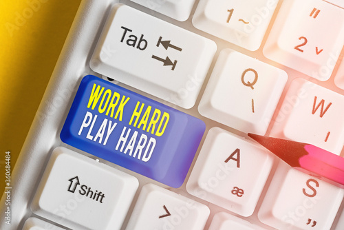 Text sign showing Work Hard Play Hard. Business photo text diligent in any activity Party at weekends Hardworking White pc keyboard with empty note paper above white key copy space photo