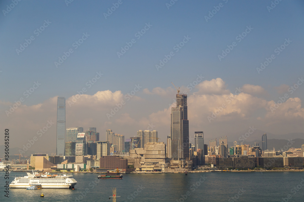 HONG KONG, CHINA - CIRCA 2020: Hong Kong Skyline and Victoria Harbor in morning. Sunset over Hong Kong bay on a clear day