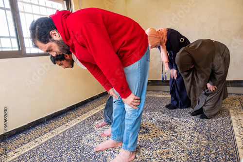 Muslim family memebers praying dohor togther photo