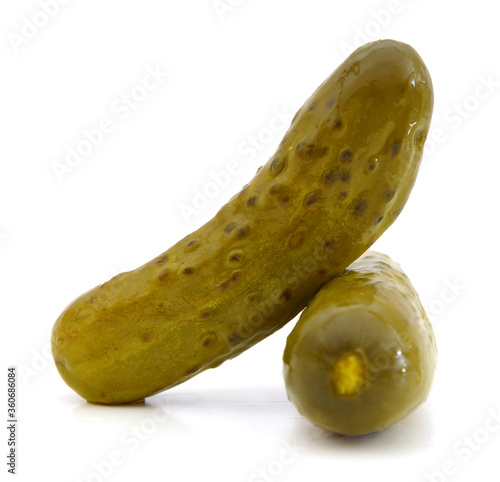 Two marinated pickled cucumbers isolated on white background