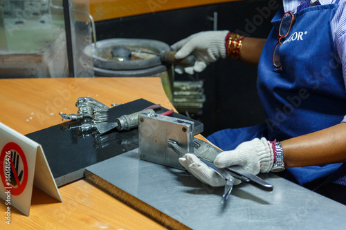 KUALA LUMPUR, MALAYSIA - CIRCA 2018: Tourists visit the production process of kitchenware,jewelry accessories from tin ore mixed with antimony and copper called Pewter. This factory is named Rayal Sal