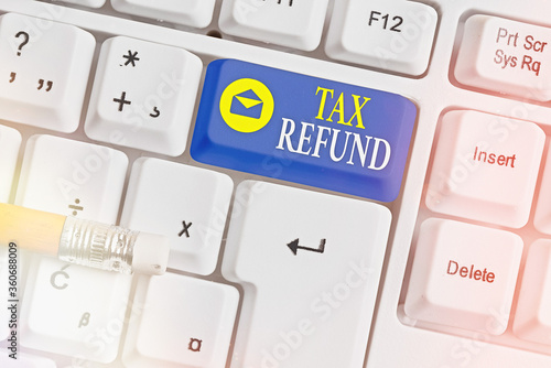 Writing note showing Tax Refund. Business concept for excess payment of paid taxes returned to business owners White pc keyboard with empty note paper above white key copy space photo