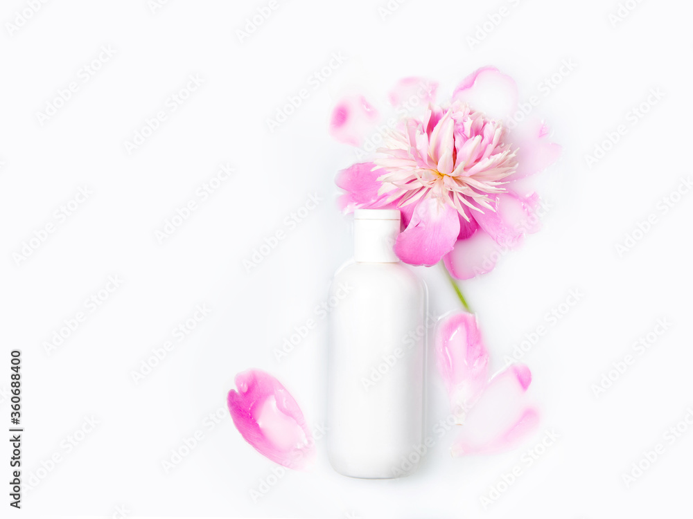 Jars of cream and pink peony in a milk bath. Gentle care. Conceptual photo: the best cosmetic tool for body and face care. Copy space, flat lay. Natural cosmetics. Jars of cream and pink peony in a milk bath. Gentle care. Conceptual photo: the best cosmetic tool for body and face care. Copy space, flat lay. Natural cosmetics.