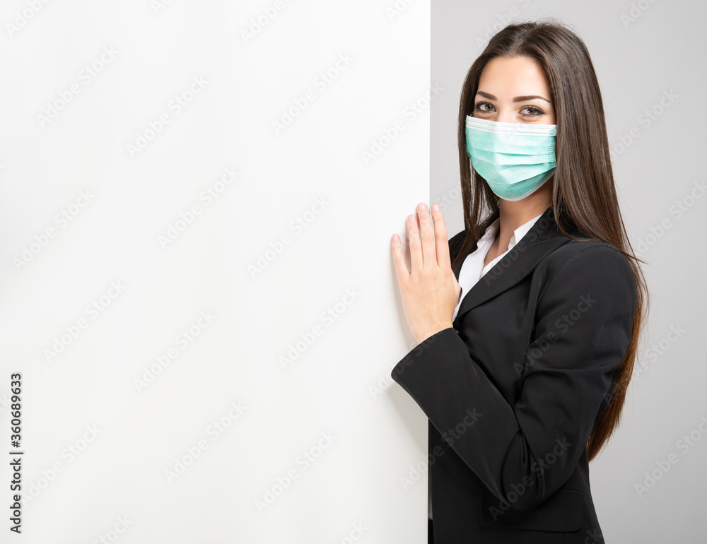Masked businesswoman in front of a white wall Masked businesswoman in front of a white wall