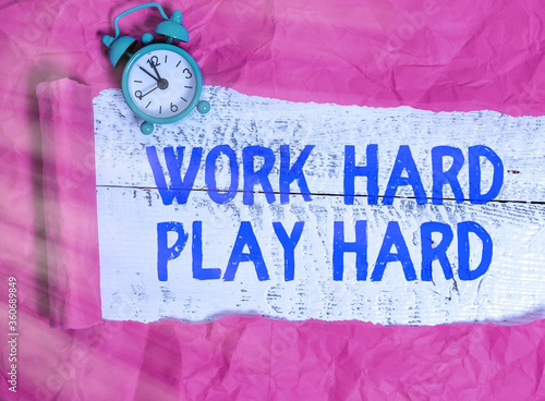 Word writing text Work Hard Play Hard. Business photo showcasing diligent in any activity Party at weekends Hardworking Rolled ripped torn cardboard placed above a wooden classic table backdrop photo