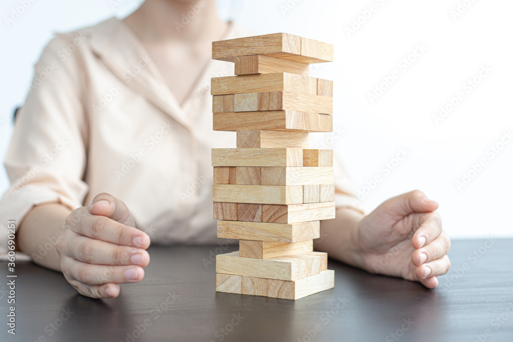 Businessman playing a wooden game in his office. Businessman playing a wooden game in his office.