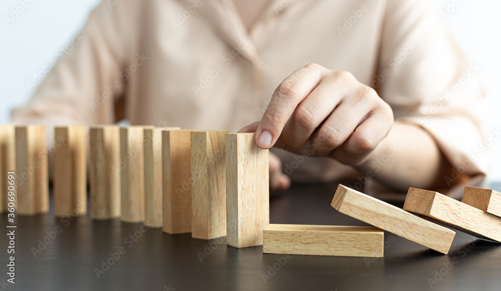 White Asian Woman Stopping Dominoes Fall In the office. White Asian Woman Stopping Dominoes Fall In the office.