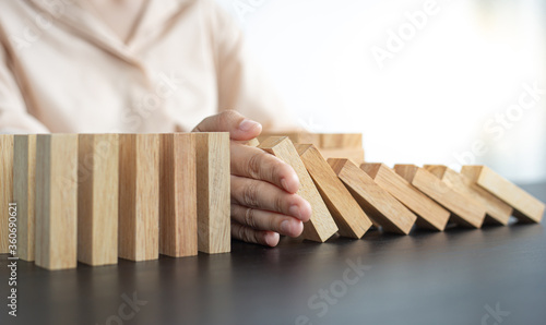 White Asian Woman Stopping Dominoes Fall In the office.