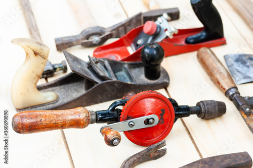 Set of vintage well used hand construction tools for handyman, hammers, on a wooden background .